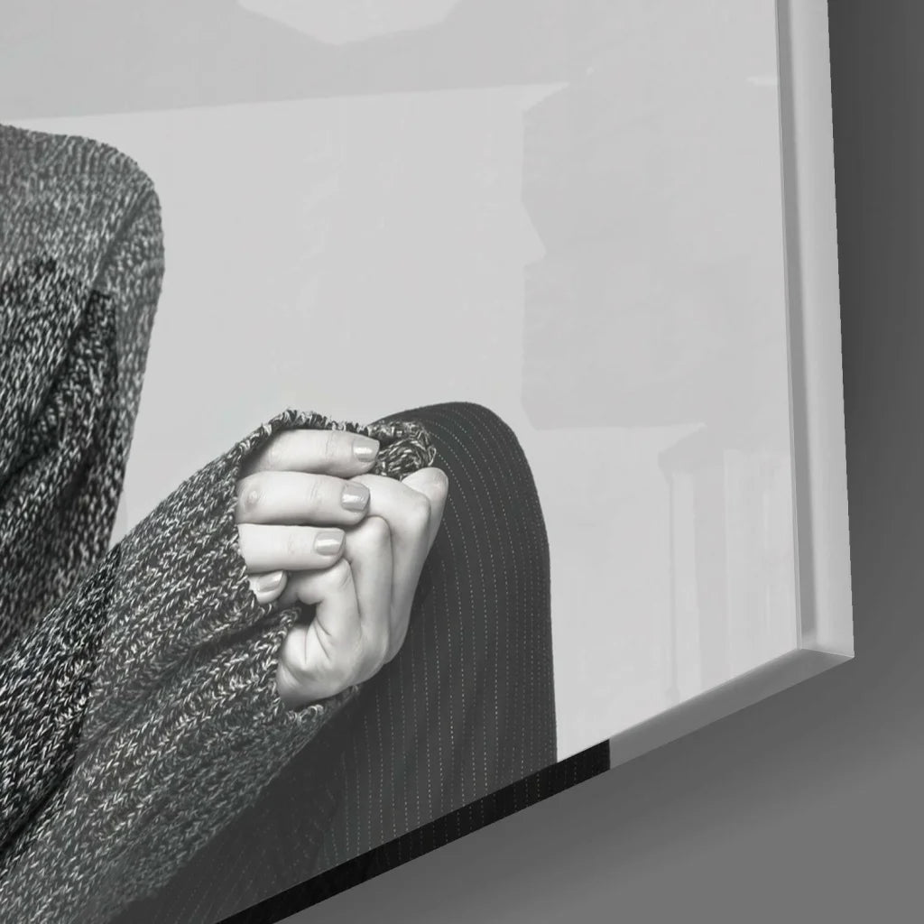 Black and white hand gripping knit sweater on surreal goat portrait glass wall art