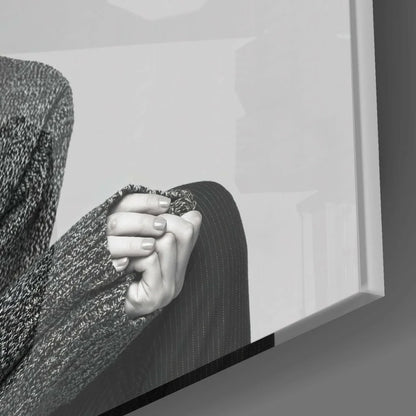 Black and white hand gripping knit sweater on surreal goat portrait glass wall art