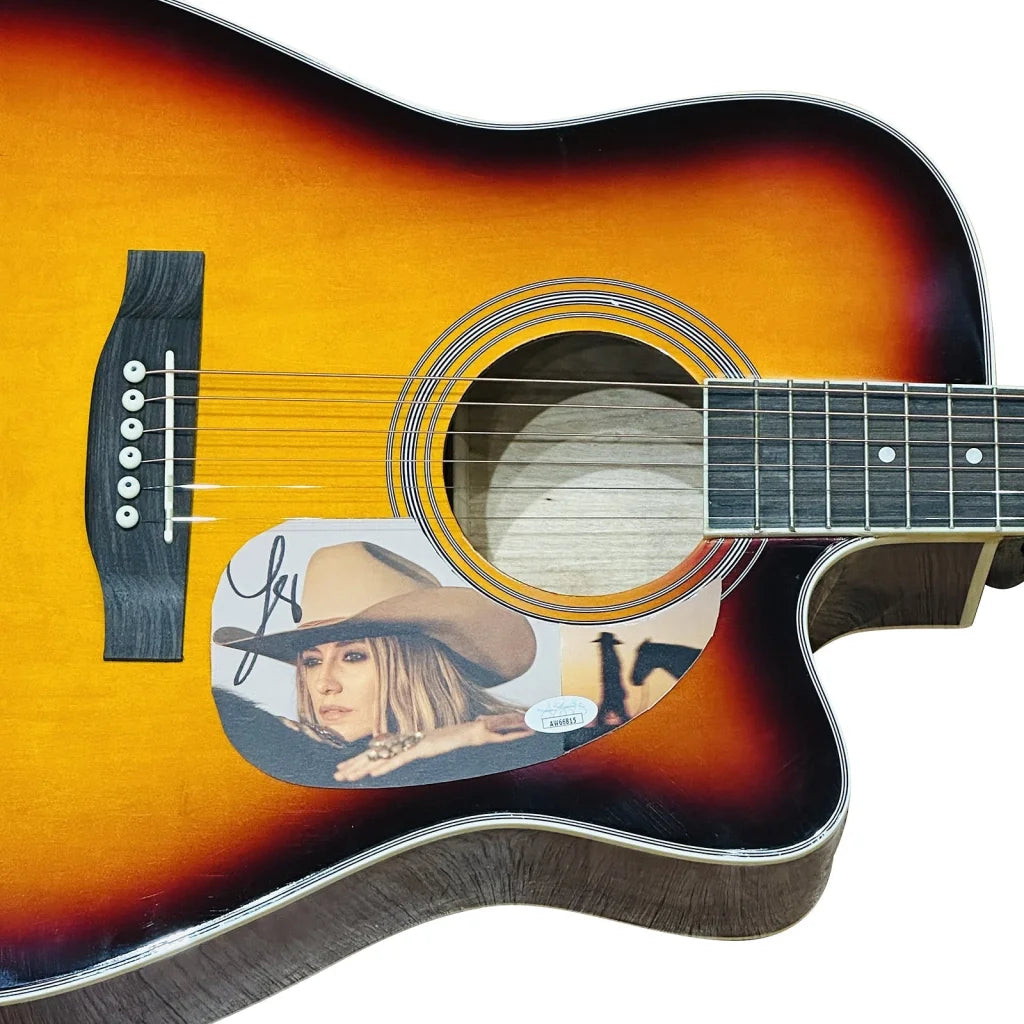 Lainey Wilson sunburst acoustic guitar with autograph and Carrie Underwood sticker