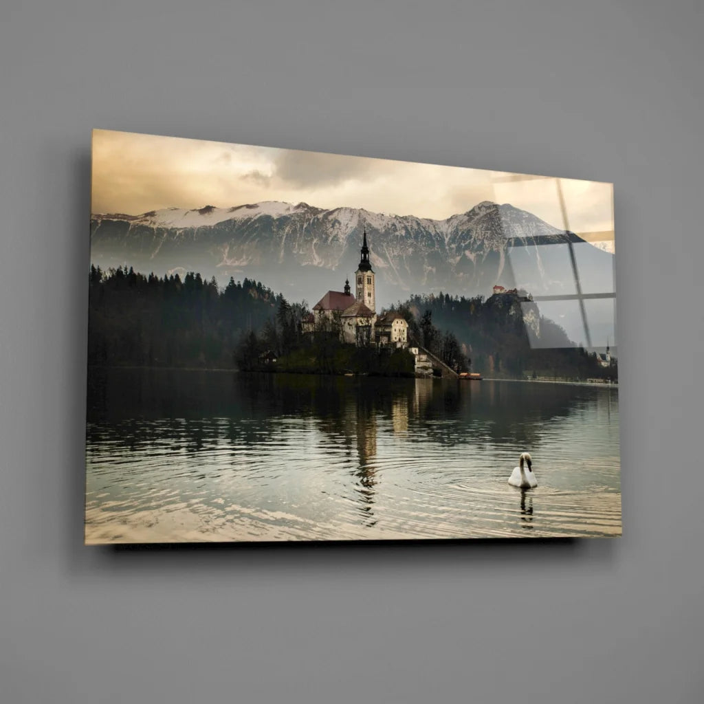 Serene alpine lake glass wall art with swan, mountains, and chapel
