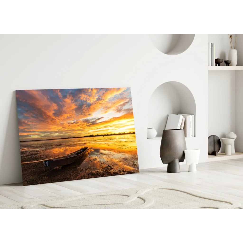 Stunning sunset boat glass wall art print with lone boat on reflective water