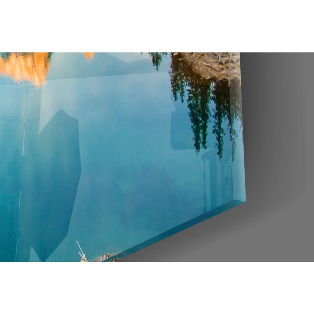 Sleek turquoise mountain lake glass wall art with blue water reflection
