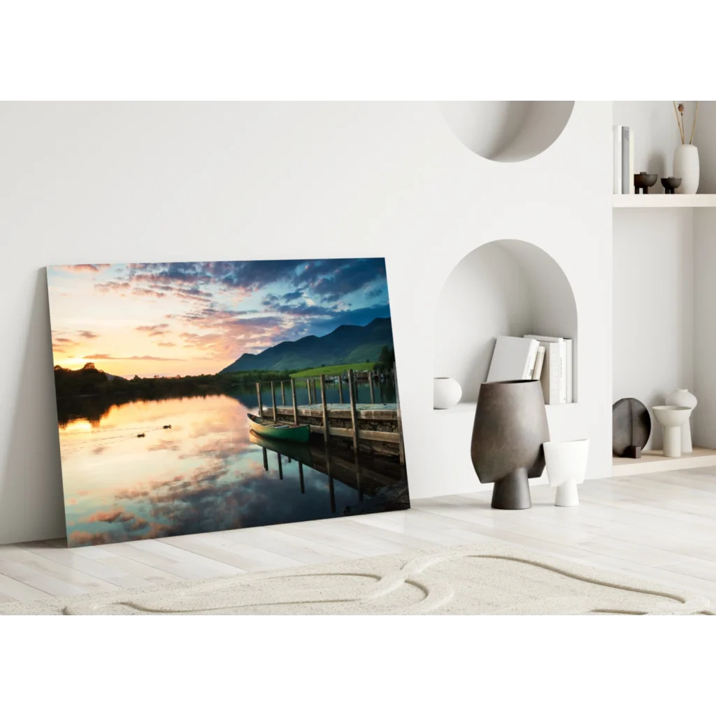 Vibrant sunset glass wall art with dock, canoe, lake, and mountains