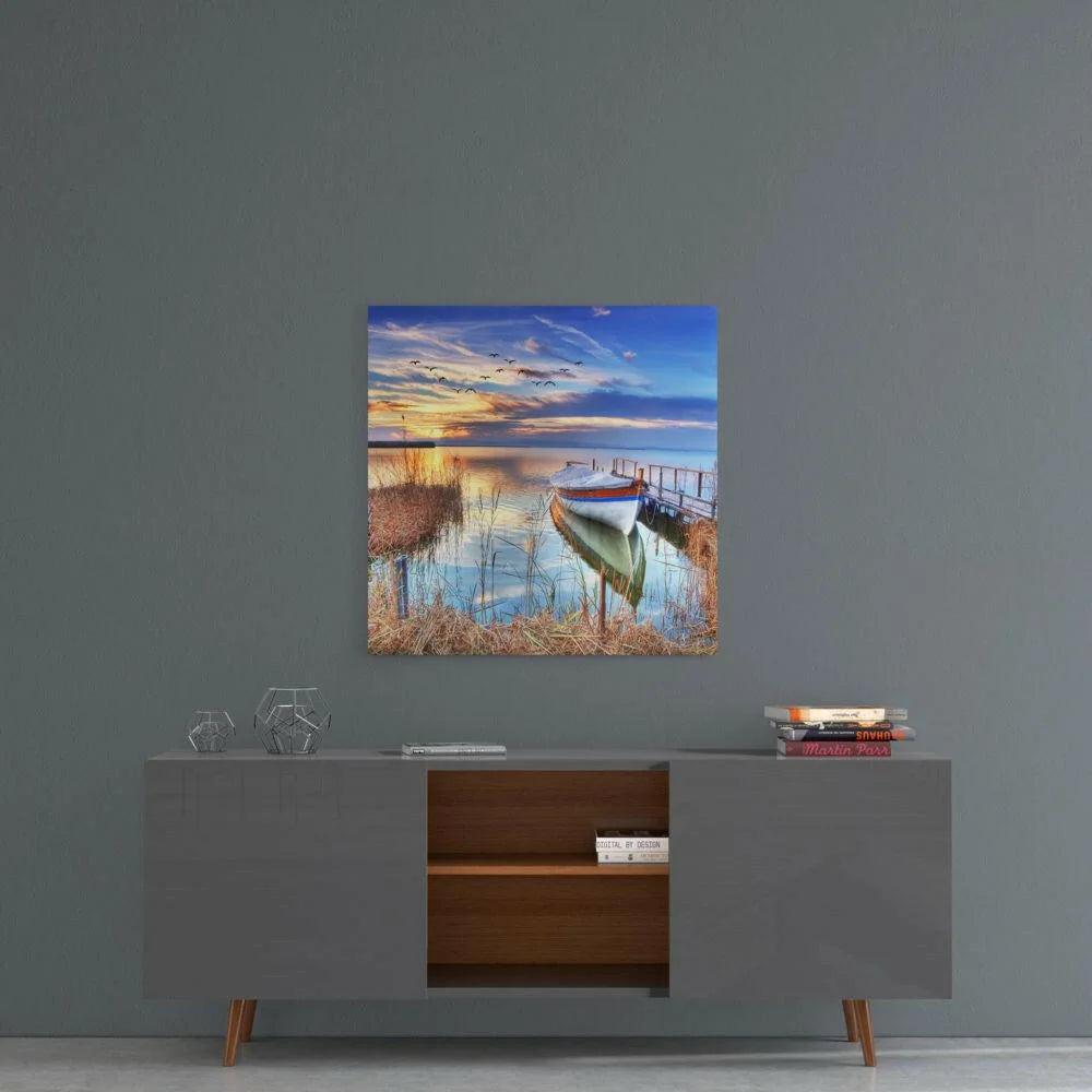 Serene lakeside sunset with white boat on dock, glass wall art