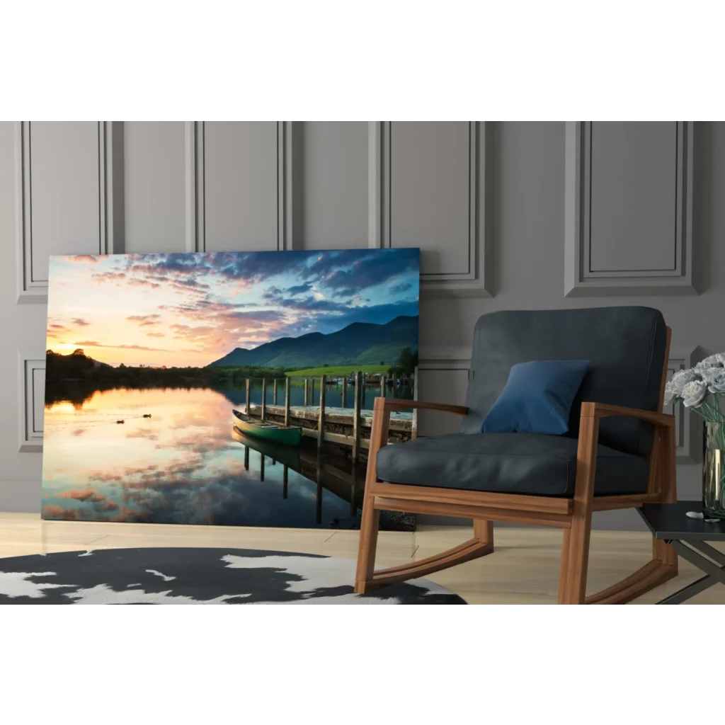 Serene sunset glass wall art of lake reflections, mountains, dock, and canoe