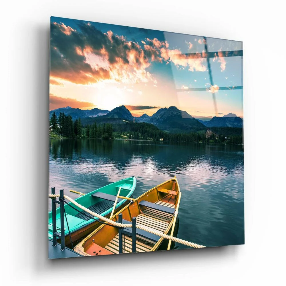 Vibrant sunset glass wall art with mountain views and colorful rowboats on lake