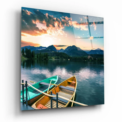 Vibrant sunset glass wall art with mountain views and colorful rowboats on lake
