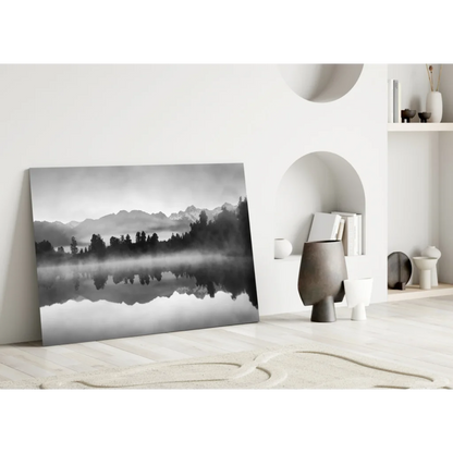 Black-and-white misty mountains glass wall art reflecting in calm lake