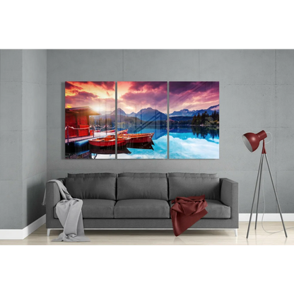 Stunning lakeside sunset triptych wall art with red boats and mountains