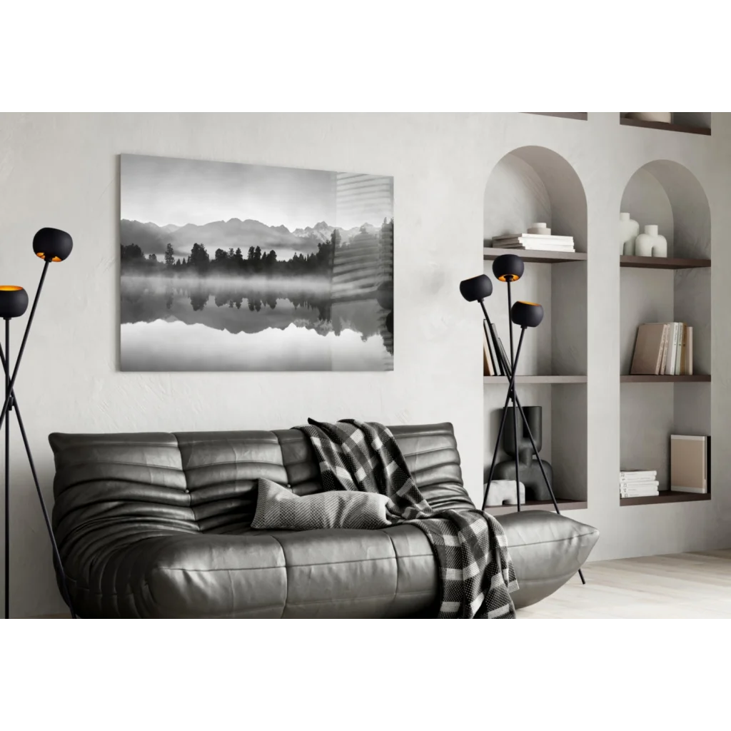 Stunning glass wall art on black leather sofa with plaid throw