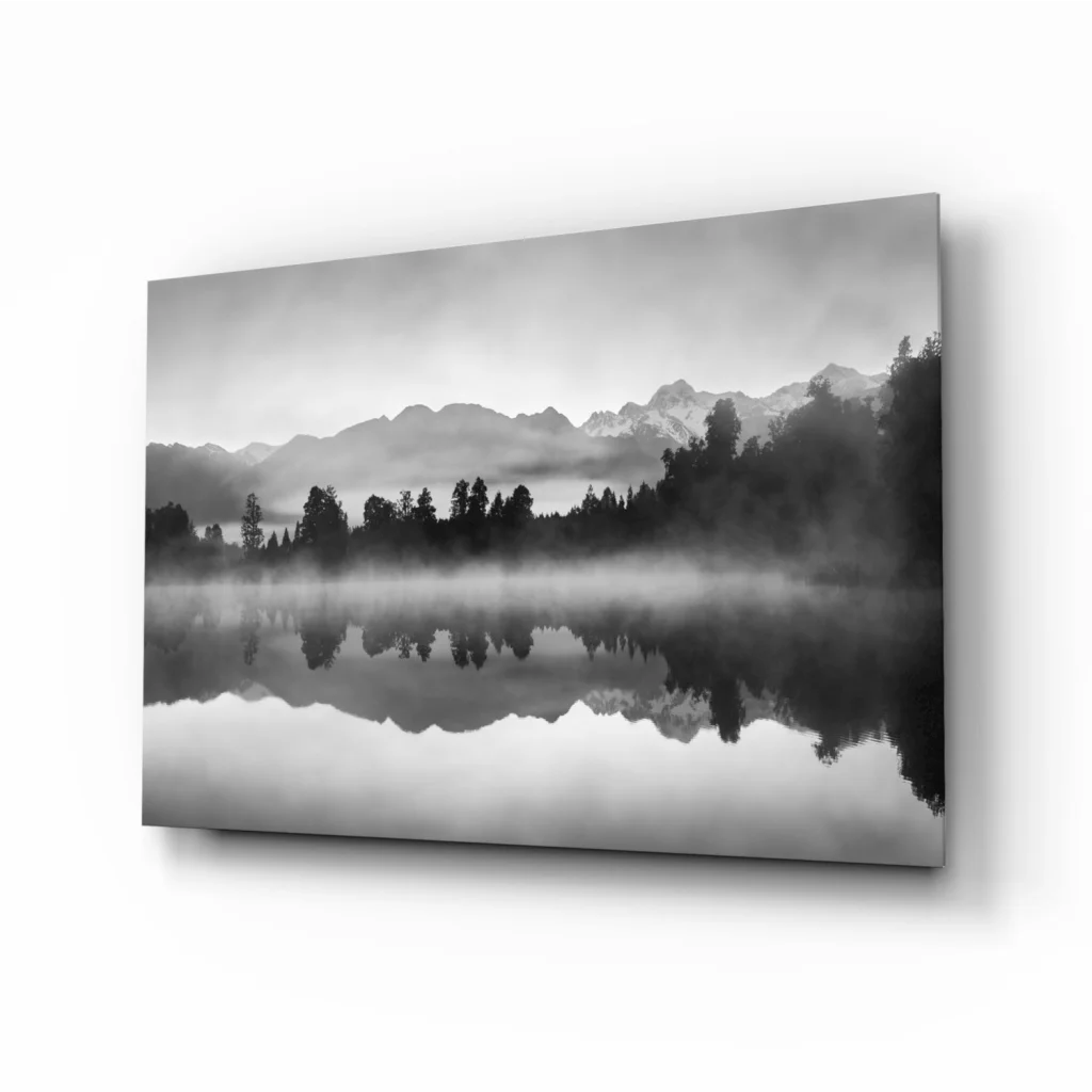 Black and white misty mountains glass wall art print on calm lake