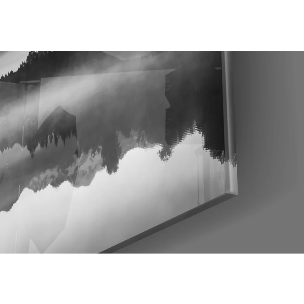 Abstract black-and-white glass wall art of misty mountains and silhouetted trees