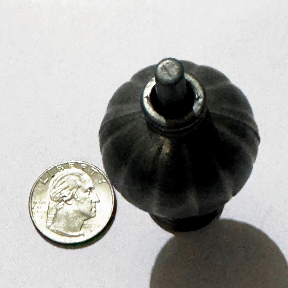Looking straight down on the assembled miniature lamp: the fluted shade, its collar ring and the slotted top of the post, next to a US quarter