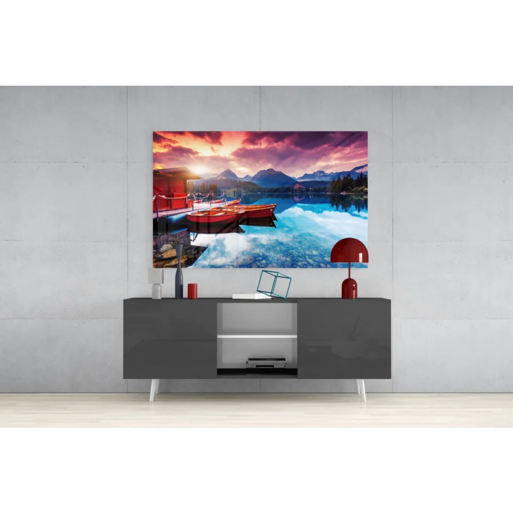 Vibrant sunset glass wall art with red boats and mountains in turquoise water