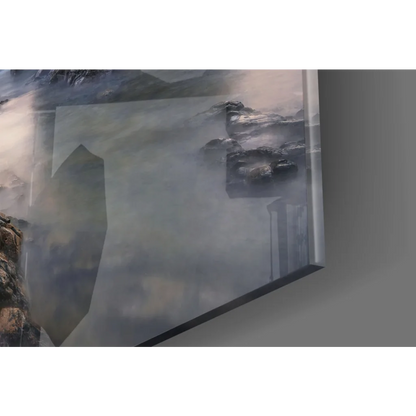 Dramatic coastal sunset glass wall art with misty mountains