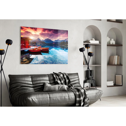 Vibrant sunset glass wall art with red boats and mountains in turquoise water