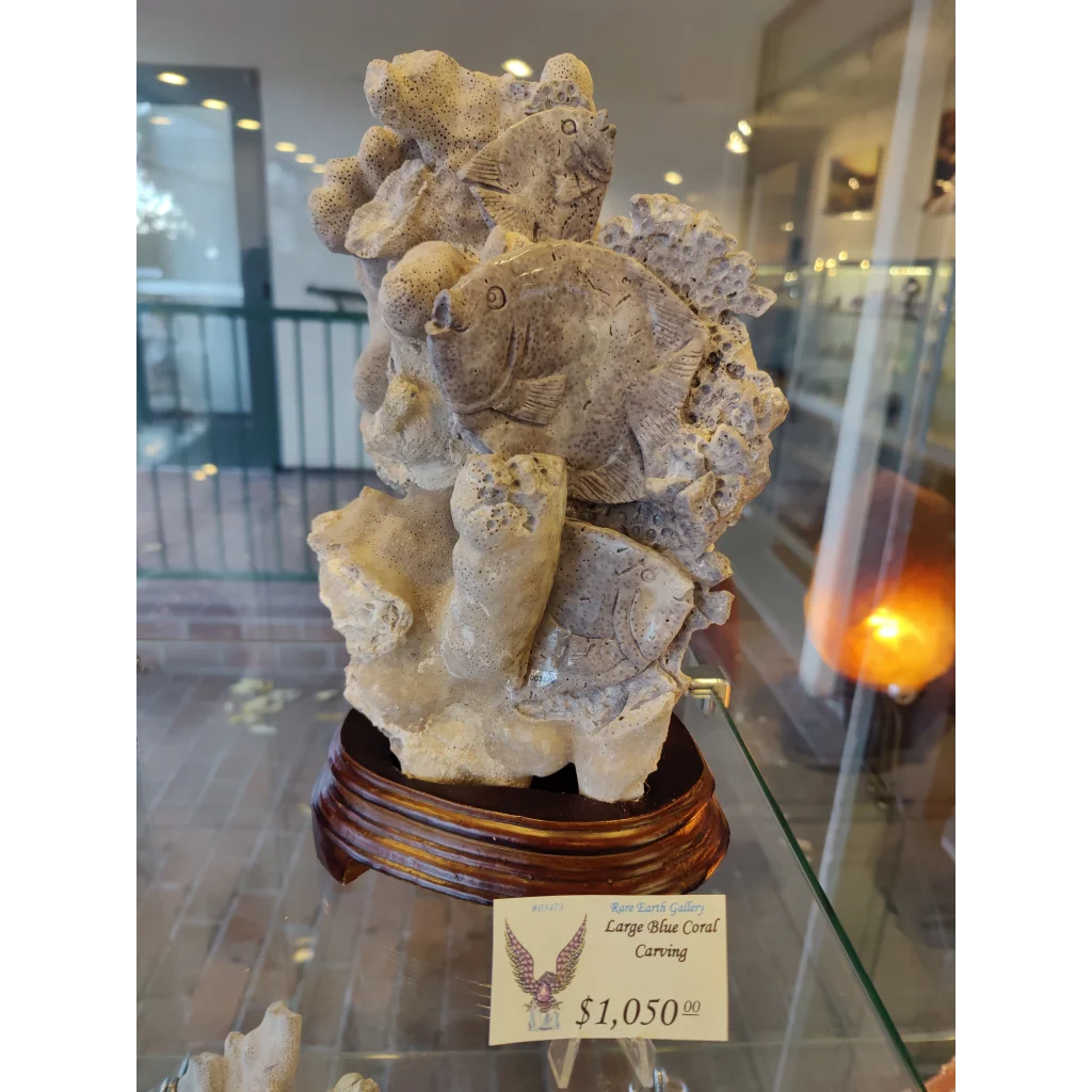 Large blue coral carving with detailed stone fish and coral textures