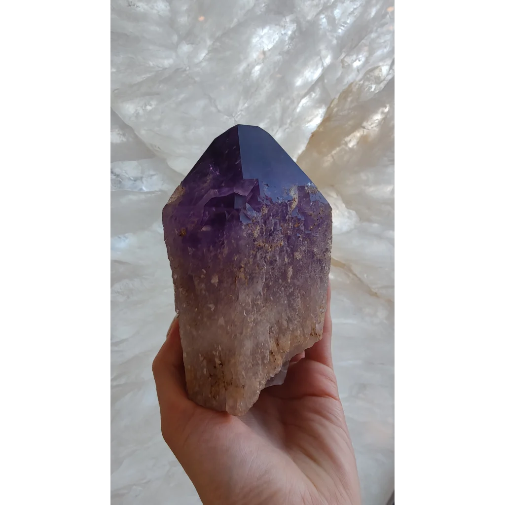 Hand holding large Bolivian amethyst point from Anahi Mine