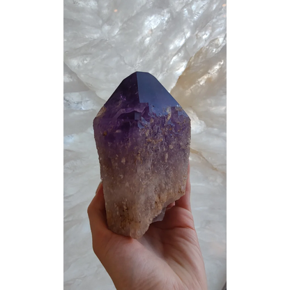 Hand holding large Bolivian amethyst point from Anahi Mine