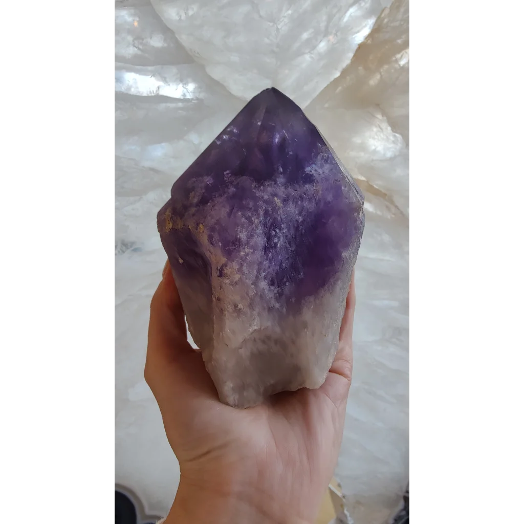 Hand holding large Bolivian amethyst point from Anahi Mine