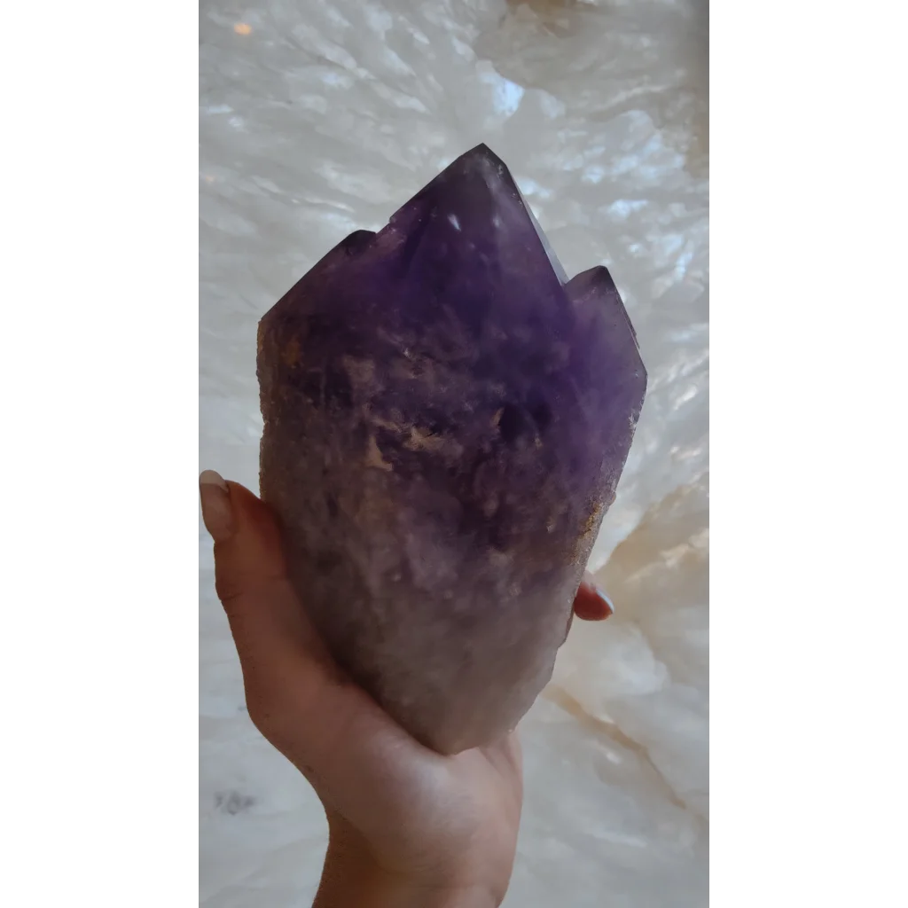 Hand holding large Bolivian amethyst point from Anahi Mine