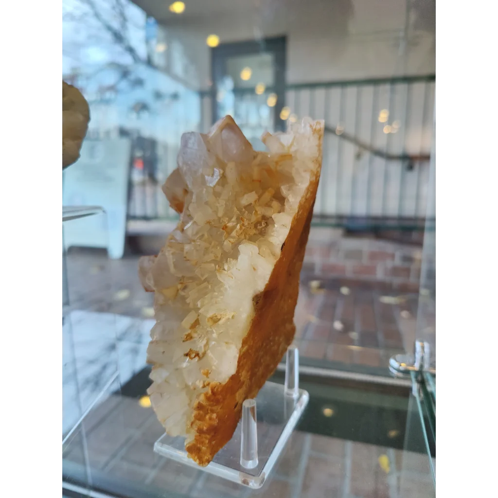 Large orange barite on quartz geode with translucent crystals