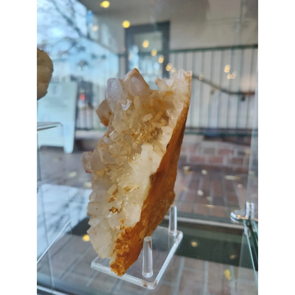 Large orange barite on quartz geode with translucent crystals