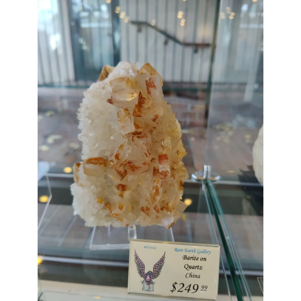 Large orange barite crystal cluster on quartz base