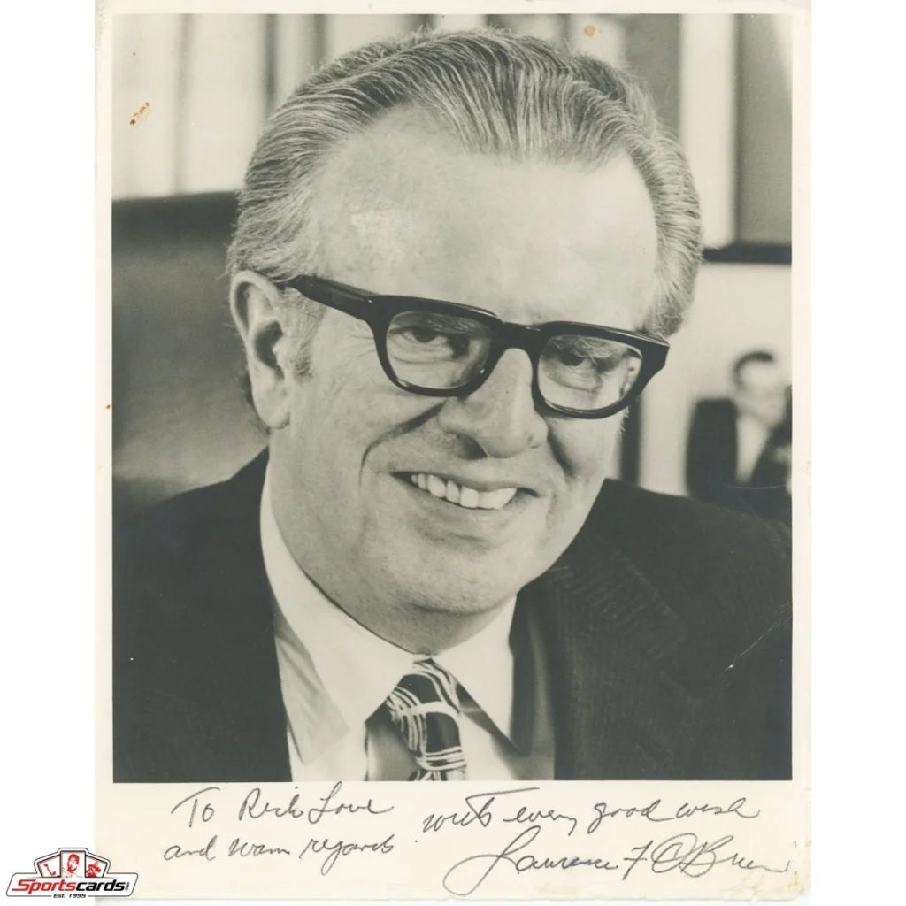 Black and white photo of legendary NBA Commissioner Larry O’Brien in suit with glasses