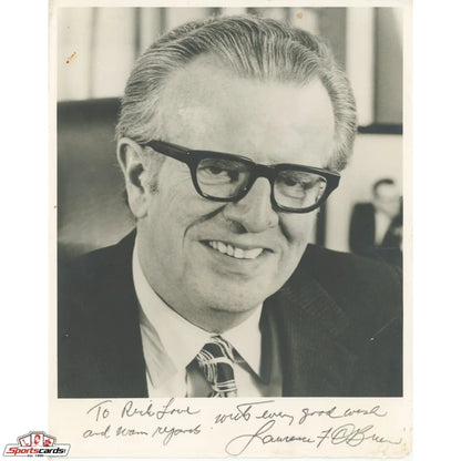 Black and white photo of legendary NBA Commissioner Larry O’Brien in suit with glasses