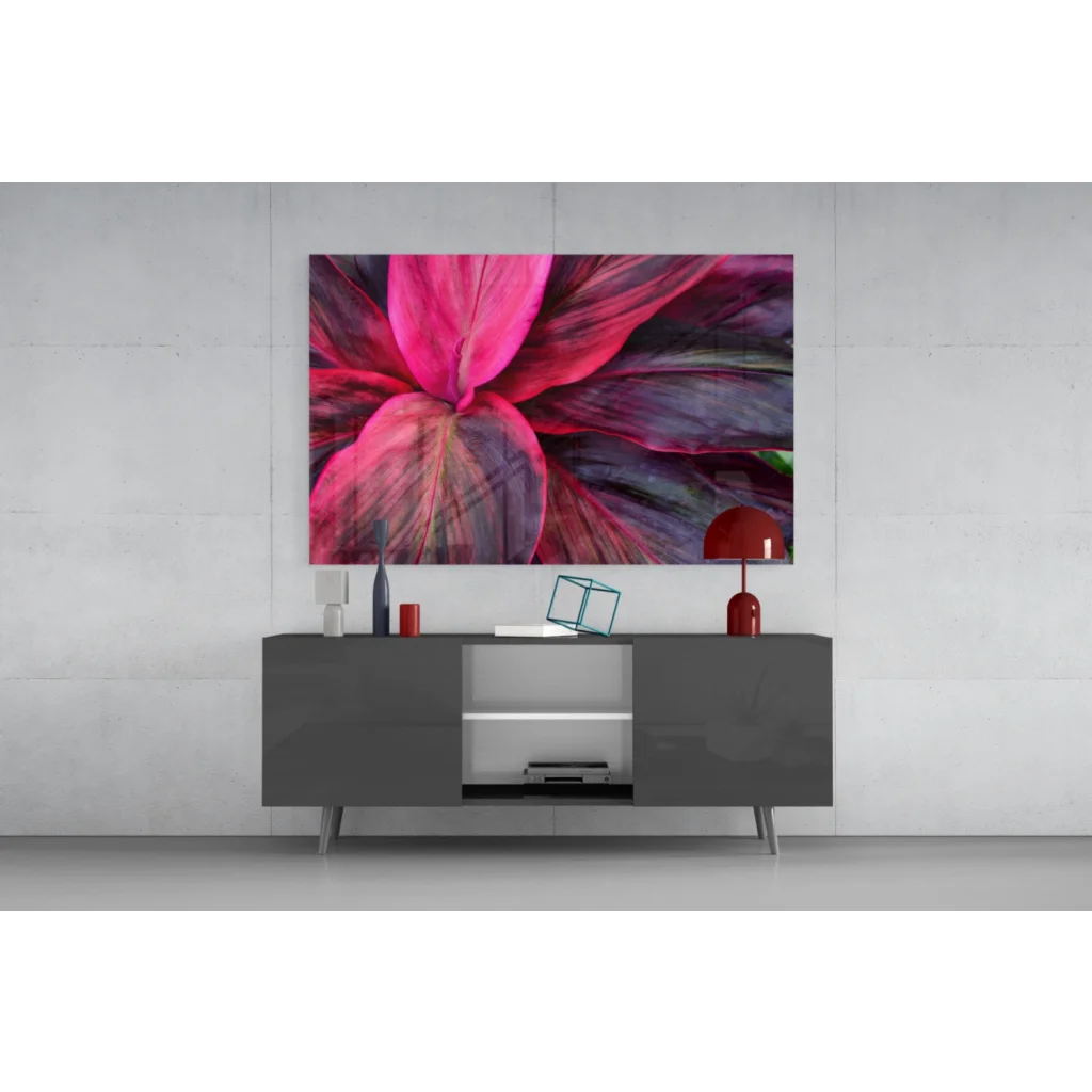 Vibrant pink purple leaf glass wall art above modern gray console