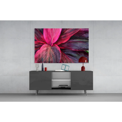 Vibrant pink purple leaf glass wall art above modern gray console