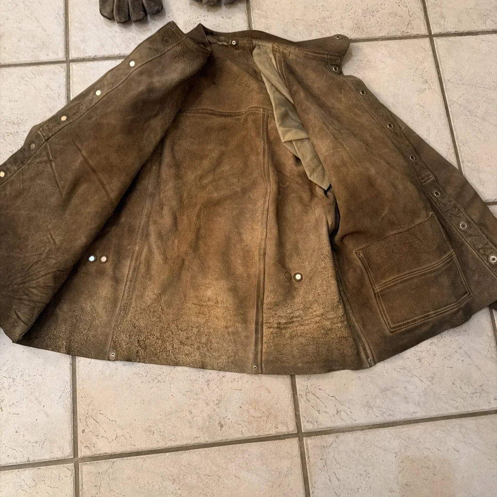 Well-worn brown leather welding jacket coat with distressed texture and stitching