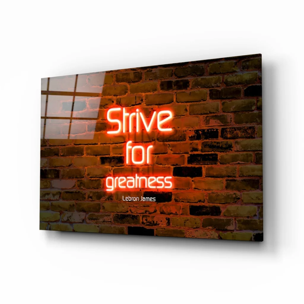 Neon orange LeBron James Strive for Greatness glass wall art on brick background