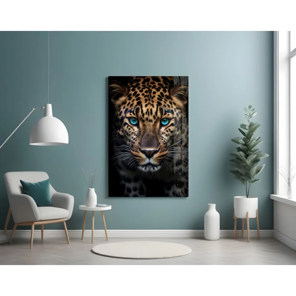 Stunning leopard glass wall art with piercing blue eyes on teal wall