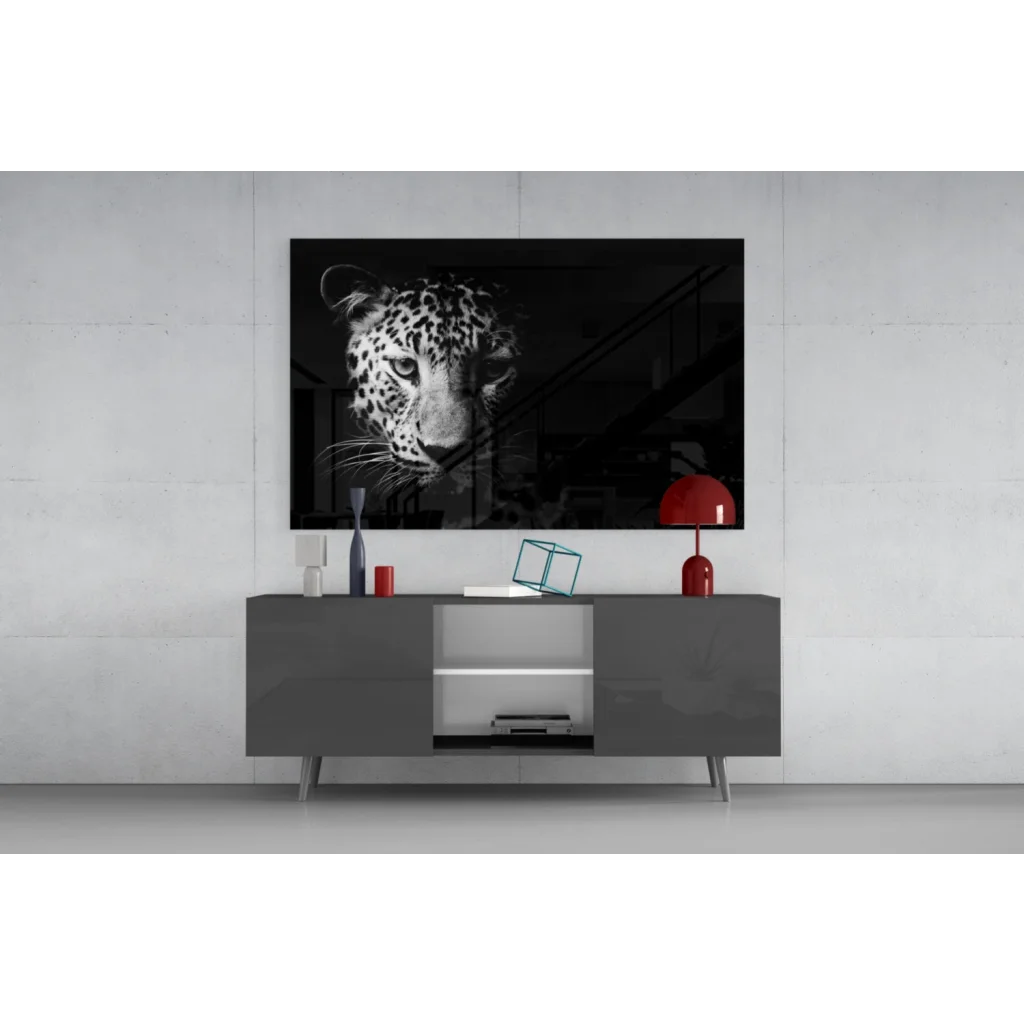 Black-and-white leopard portrait canvas wall art above gray console