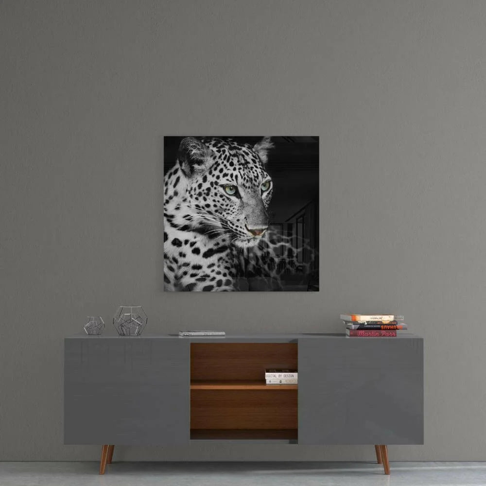 Black and white leopard head glass wall art with piercing green eyes