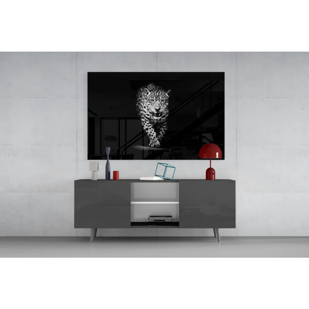 Black-and-white leopard motion print in glass wall art above gray console