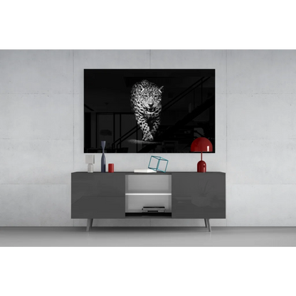 Black-and-white leopard motion print in glass wall art above gray console
