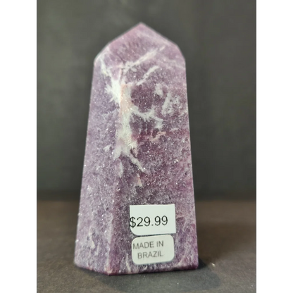 Lepidolite polished obelisk tower sculpture featuring a polished purple amethyst crystal point with white veining upright on base