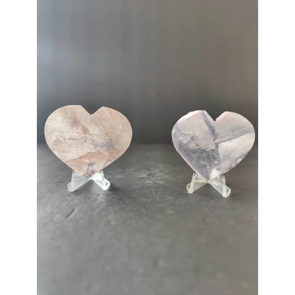 Two heart-shaped quartz crystal slices in pinkish hue and clear gray veining for lepidolite tower and heart sculptures