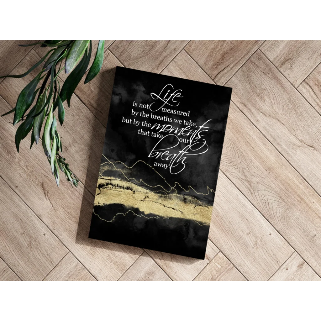 Black canvas print with gold foil accents and white cursive text on breathtaking moments insigne aluminum prints