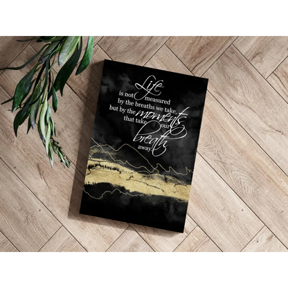 Black canvas print with gold foil accents and white cursive text on breathtaking moments insigne aluminum prints