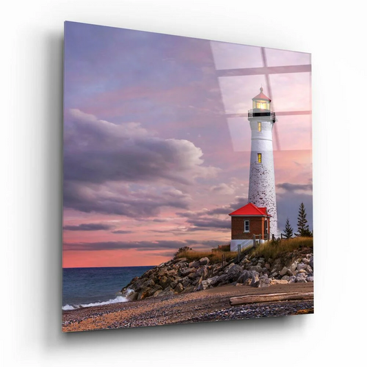 White lighthouse with red roof on rocky cliff in stunning glass wall art sunset sky