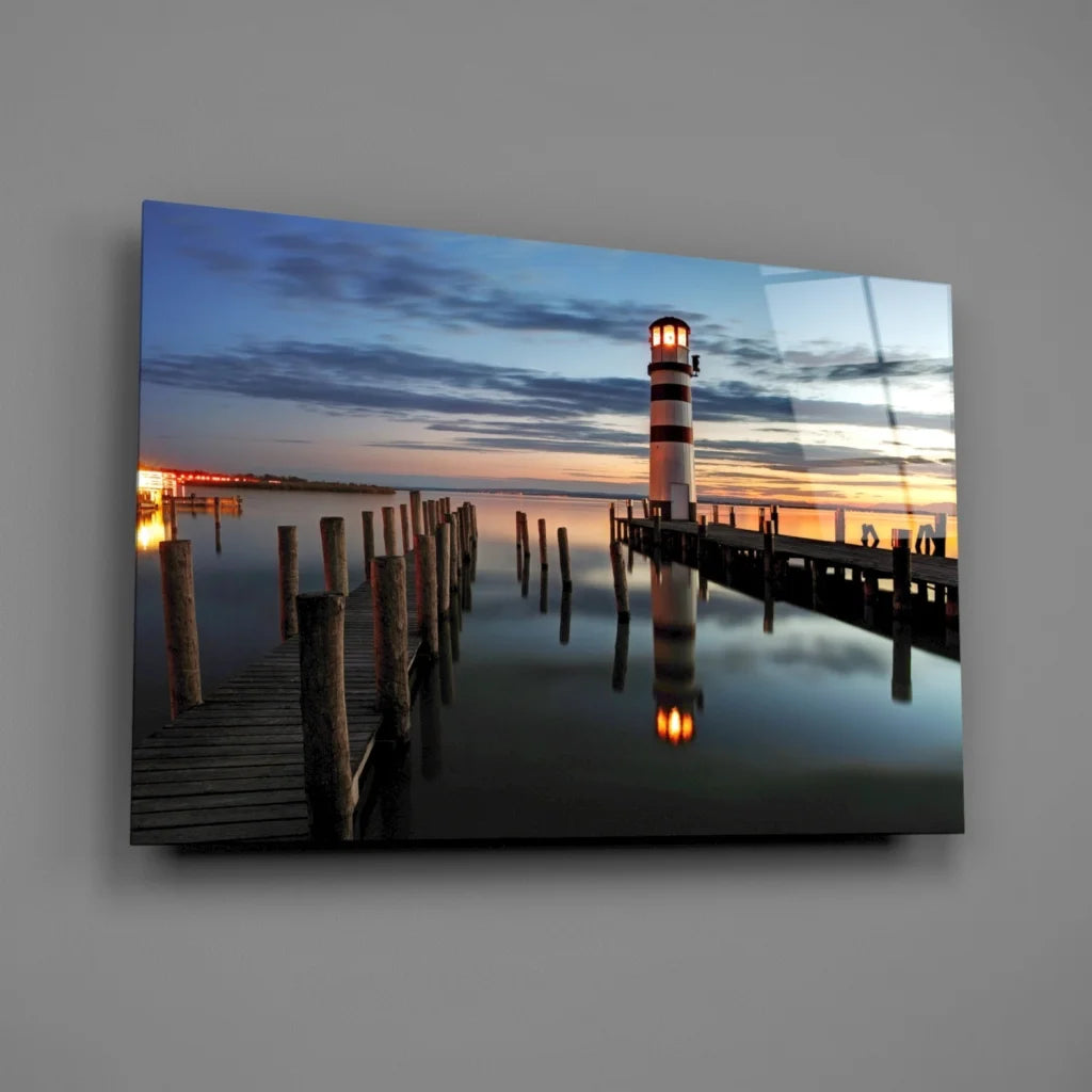 Sleek glass wall art of striped lighthouse at serene dusk harbor