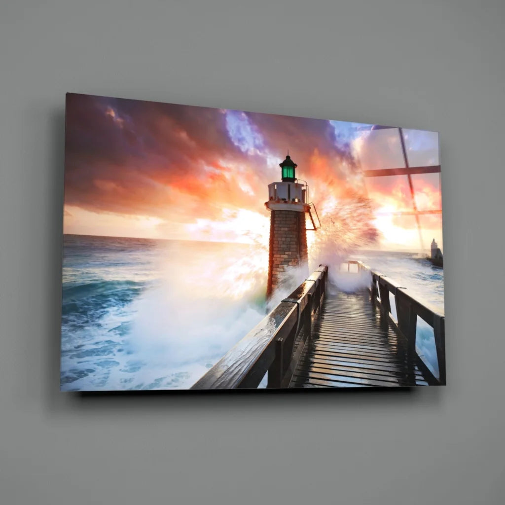 Vibrant lighthouse sunset glass wall art with glowing green lantern and crashing waves