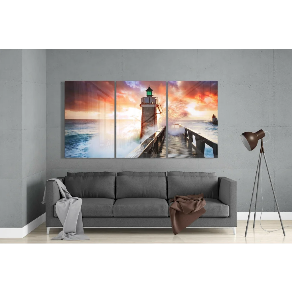 Vibrant lighthouse sunset triptych canvas wall art with orange skies and crashing waves