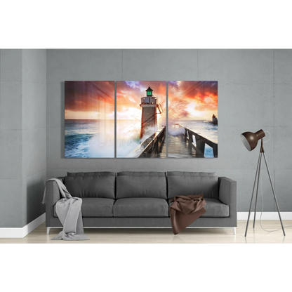 Vibrant lighthouse sunset triptych canvas wall art with orange skies and crashing waves