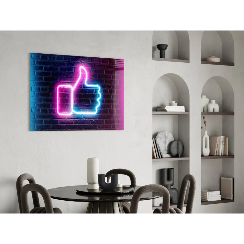 Vibrant neon pink and blue thumbs-up glass wall art on faux brick