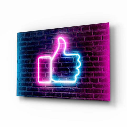 Vibrant neon pink and blue thumbs up glass wall art on dark brick wall